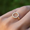 Hand wearing a Rosecliff small open circle ring featuring twelve 2 mm round cut white topaz prong set in 14k yellow gold