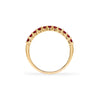 Rosecliff stackable ring featuring eleven 2 mm faceted round cut garnets prong set in 14k yellow gold - standing view