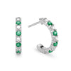Two Rosecliff huggie earrings in 14k white gold each featuring nine alternating 2mm round cut emeralds and diamonds