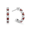 Two Rosecliff huggie earrings in 14k white gold each featuring nine alternating 2mm round cut prong set garnets and diamonds