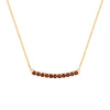 Rosecliff bar necklace with eleven 2 mm faceted round cut garnets prong set in solid 14k yellow gold - front view