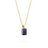 Adelaide paper clip chain and a Warren pendant with an emerald cut bezel set sapphire gemstone in 14k gold - angled view