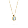 Adelaide paper clip chain and a Warren pendant with an emerald cut Nantucket blue topaz gemstone in 14k gold - angled view