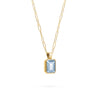 Adelaide paper clip chain and a Warren pendant with an emerald cut bezel set aquamarine gemstone in 14k gold - angled view