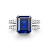 Warren ring in 14k white gold with accent diamonds featuring one 10 x 8 mm emerald cut bezel set sapphire - front view