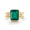 Warren ring in 14k yellow gold featuring one 10 x 8 mm emerald cut bezel set emerald - front view