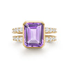 Warren ring in 14k yellow gold with accent diamonds featuring one 10 x 8 mm emerald cut bezel set amethyst - front view
