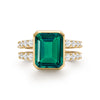 Warren ring in 14k yellow gold with accent diamonds featuring one 10 x 8 mm emerald cut bezel set emerald - front view