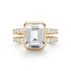 Warren ring in 14k gold with accent diamonds featuring one 10 x 8 mm emerald cut bezel set white topaz - front view