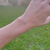Woman with a Grand & Classic bracelet featuring one 6 mm and four 4 mm Nantucket Blue Topaz bezel set in 14k gold