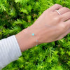 Female with a gold Bayberry Grand & Classic cable chain bracelet with 4 mm Nantucket blue topaz & 6 mm turquoise gemstones