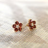 Pair of 14k yellow gold Greenwich 5 Birthstone earrings each featuring five 4 mm round cut garnets and one 2.1 mm diamond