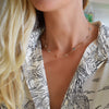 Woman wearing a Bayberry Grand 11 Birthstone necklace featuring eleven 6 mm briolette cut gemstones bezel set in 14k gold