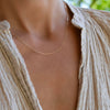 Woman wearing a 14k yellow gold Adelaide mini necklace featuring 5.2 x 2 mm paperclip chain links