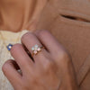 Woman wearing a Greenwich ring featuring four 4 mm faceted round cut opals and one 2.1 mm diamond prong set in 14k gold