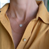 Woman with two 14k yellow gold necklaces including a Greenwich necklace featuring five 4 mm opals and one 2.1 mm diamond