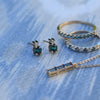 Jewelry featuring a pair of gold Greenwich 1 Birthstone earrings each featuring one 4 mm alexandrite and one 2.1 mm diamond
