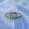 Pair of Rosecliff stackable rings each featuring eleven alternating 2mm alexandrites and diamonds prong set in 14k gold