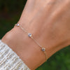 Woman with a Bayberry cable chain birthstone bracelet featuring three 4 mm briolette aquamarines bezel set in 14k gold