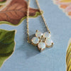 Greenwich cable chain necklace featuring five 4 mm faceted round opals and one 2.1 mm diamond bezel set in 14k yellow gold