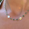 Woman with a gold Newport necklace featuring 4 mm briolette gemstones and two 1/4” flat letter-engraved discs