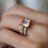 Woman with a Warren ring in 14k yellow gold with accent diamonds featuring one 10 x 8 mm emerald cut bezel set rose quartz