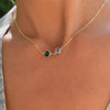 Woman with a Grand 14k yellow gold 1.17 mm cable chain necklace featuring two 6 mm briolette cut bezel set gemstones