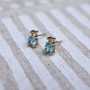 Pair of 14k gold Greenwich 1 Birthstone earrings each featuring one 4 mm round cut Nantucket blue topaz & one 2.1 mm diamond