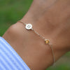 Woman wearing a 14k yellow gold Classic bracelet featuring one citrine and one 1/4” flat disc engraved with the letter H