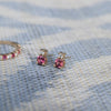 Pair of 14k gold Greenwich 1 Birthstone earrings each featuring one 4 mm round cut pink tourmaline and one 2.1 mm diamond