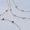 Multiple Bayberry cable chain birthstone bracelets each featuring three 4 mm briolette gemstones bezel set in 14k yellow gold