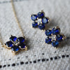Pair of gold earrings and a Greenwich necklace featuring five 4 mm round cut sapphires & one 2.1 mm diamond set in 14k gold