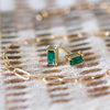 Close up of Providence Emerald stud earrings with petite baguette stones set in 14k yellow gold