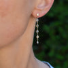 Woman wearing a Personalized Classic dangle earring featuring six gemstones bezel set in 14k yellow gold