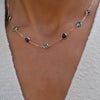 Woman wearing a Grand 14k yellow gold 1.17 mm cable chain necklace featuring seven 6 mm briolette cut bezel set gemstones