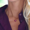 Woman with a Greenwich cable chain necklace featuring five 4 mm round rubies and one 2.1 mm diamond bezel set in 14k gold