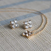 Necklace and a pair of 14k gold Greenwich 4 Birthstone earrings each featuring four 4 mm white topaz and one 2.1 mm diamond