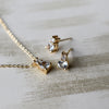 Necklace and a pair of 14k gold Greenwich 1 Birthstone earrings each featuring one 4 mm white topaz and one 2.1 mm diamond