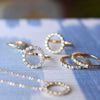 Assorted Rosecliff jewelry including an open circle ring featuring sixteen 2 mm round cut white topaz prong set in 14k gold