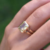 Woman's finger wearing a Warren ring in 14k yellow gold featuring one 10 x 8 mm emerald cut bezel set lemon verbena quartz