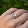 Hand wearing two rings including a Greenwich ring featuring two 4 mm gemstones and one 2.1 mm diamond prong set in 14k gold
