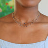 Woman wearing a 14k gold Hope Newport necklace featuring alternating 4 mm amethysts, Nantucket blue topaz and sapphires