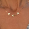 Woman with a 14k yellow gold cable chain necklace featuring three 1/4” flat engraved letter discs, spelling M-heart-M