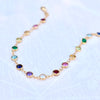 Newport 14k yellow gold bracelet featuring eighteen 4 mm briolette cut bezel set rainbow hued gemstones