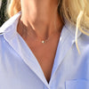 Woman wearing a 14k yellow gold cable chain necklace featuring one 1/4” flat disc engraved with the letter P