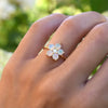 Hand wearing a Greenwich ring featuring five 4 mm faceted round cut opals and one 2.1 mm diamond prong set in 14k gold