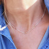 Woman wearing a Bayberry 11 Birthstone necklace featuring 4 mm briolette citrines bezel set in sterling silver