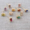 Close-up of assorted Providence stud earrings with petite baguette stones set in 14k yellow gold